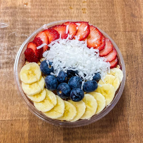 Juice House of Tuckahoe's colorful acai bowl with strawberries, blueberries, bananas, and shredded coconut.